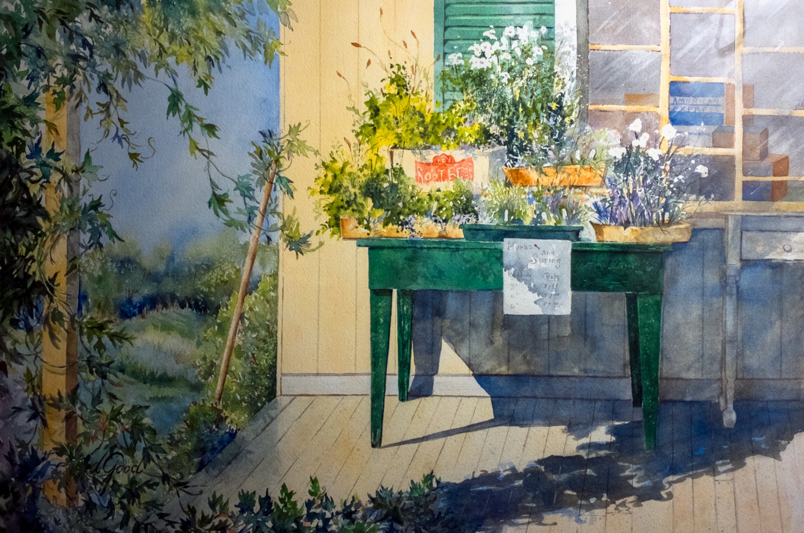 Potted flowers catch the sunlight on a green porch table beside a window.