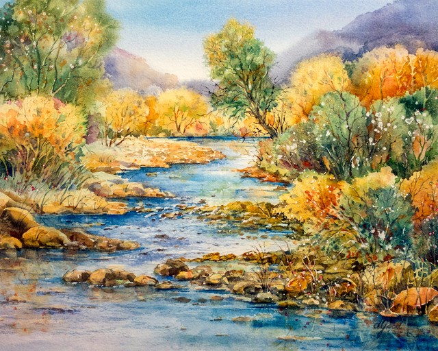 A clear river winds between green and gold trees toward low Texas hills.