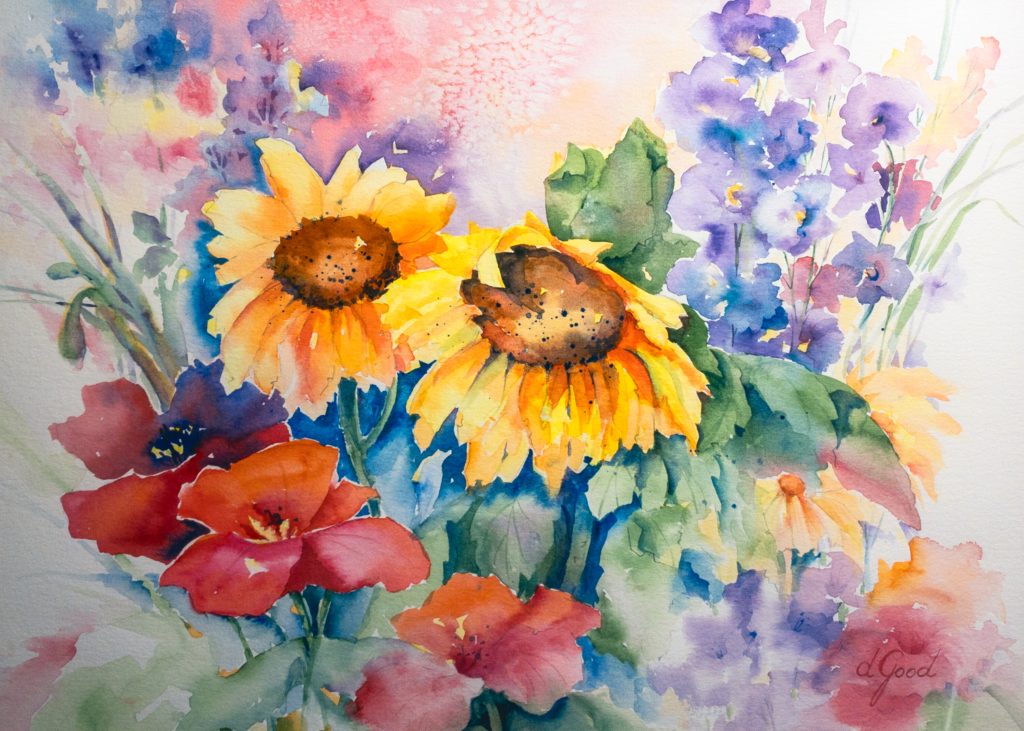 Yellow sunflowers, red poppies and purple flowers gather in a bright bouquet.